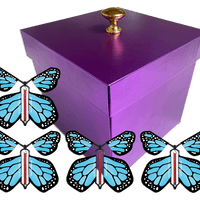 Purple Exploding Butterfly Gift Box With 4 Blue Monarch Wind Up Flying Butterflies from butterflyers.com